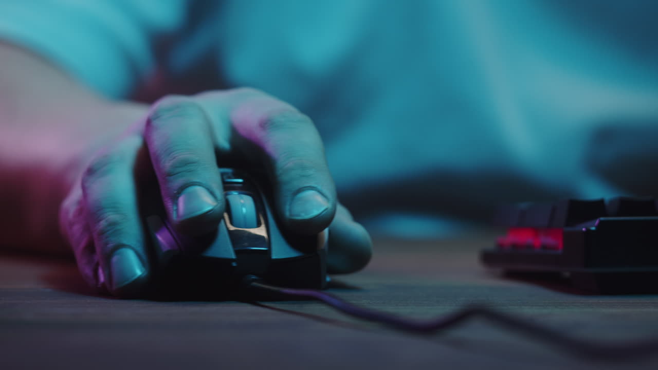 Close-Up of Hand Clicking and Scrolling a Computer Mouse with Neon Lights