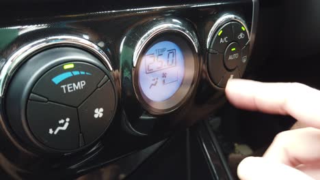 Slowmotion-while-using-finger-turn-on-the-air-condition-in-the-car