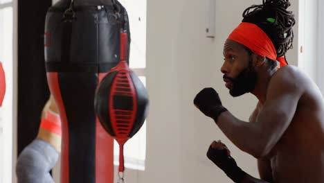 male boxer practicing boxing in fitness studio 4k