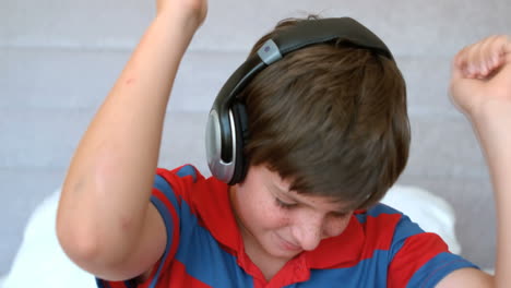 young boy enjoying music with headphones