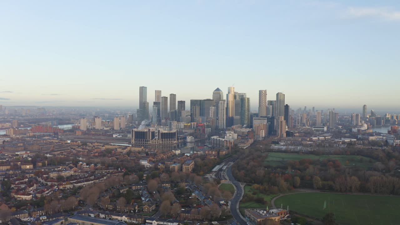 일출 시 남쪽에서 카나리 워프 고층 빌딩의 돌리 포워드 드론 샷