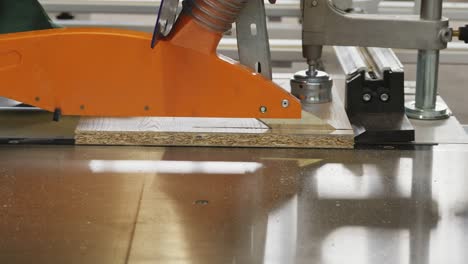 closeup process of carpenter worker with circular saw machine