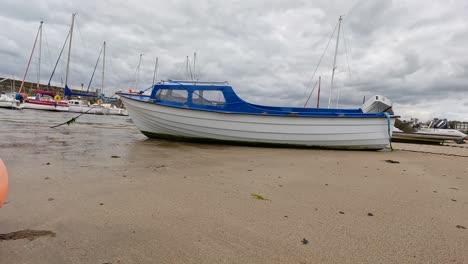 boats anchored on a sandy, windy bay