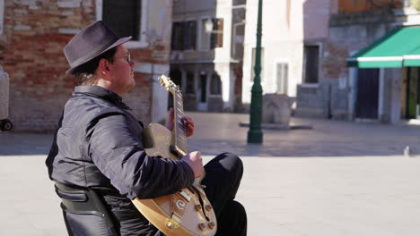 street musician in venice playing jazz guitar