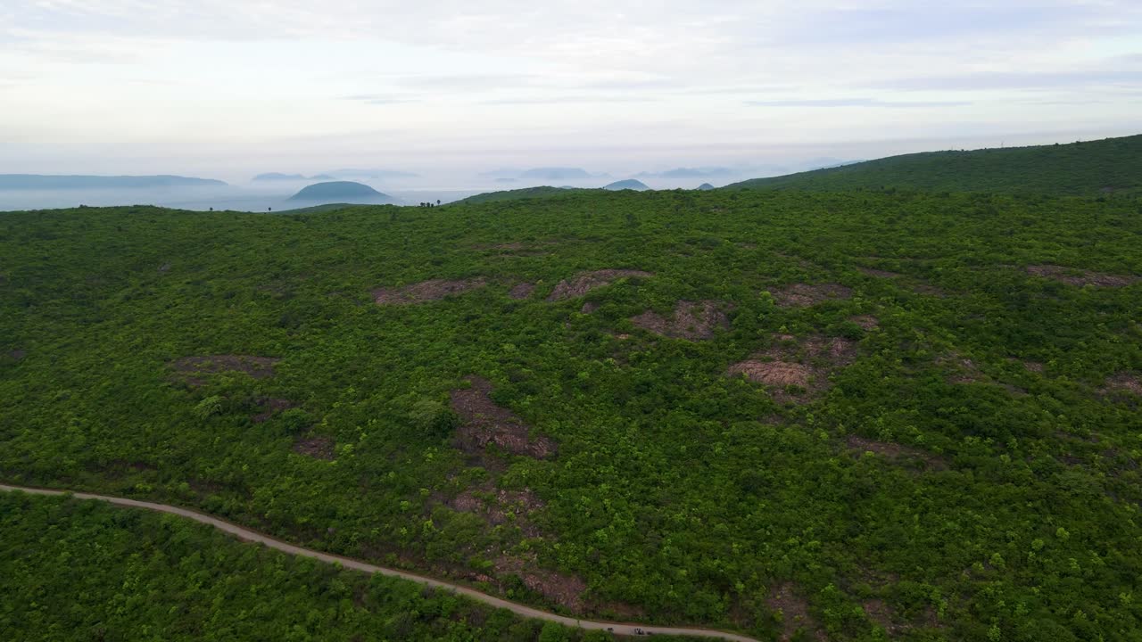 Aerial drone shot showcasing the beauty of Vizag’s mountain forest, with the deep blue ocean expanding in the background.