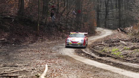 the valasska rally and the porsche race car coming out of a bend into a short section between tree trunks will pass part of the circuit in the middle of the forest road captured in 120fps slow motion.