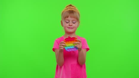 Child-girl-playing-push-pop-it-bubble-stress-anxiety-relief-squeeze-sensory-game-toys,-chroma-key