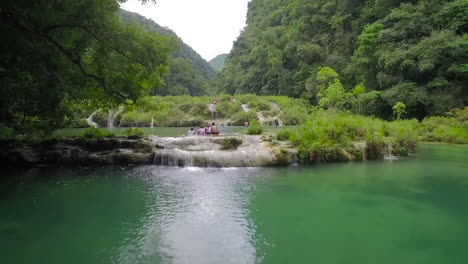 an aerial over remarkable waterfalls and green polls on the semuc champey river in guatemala 3