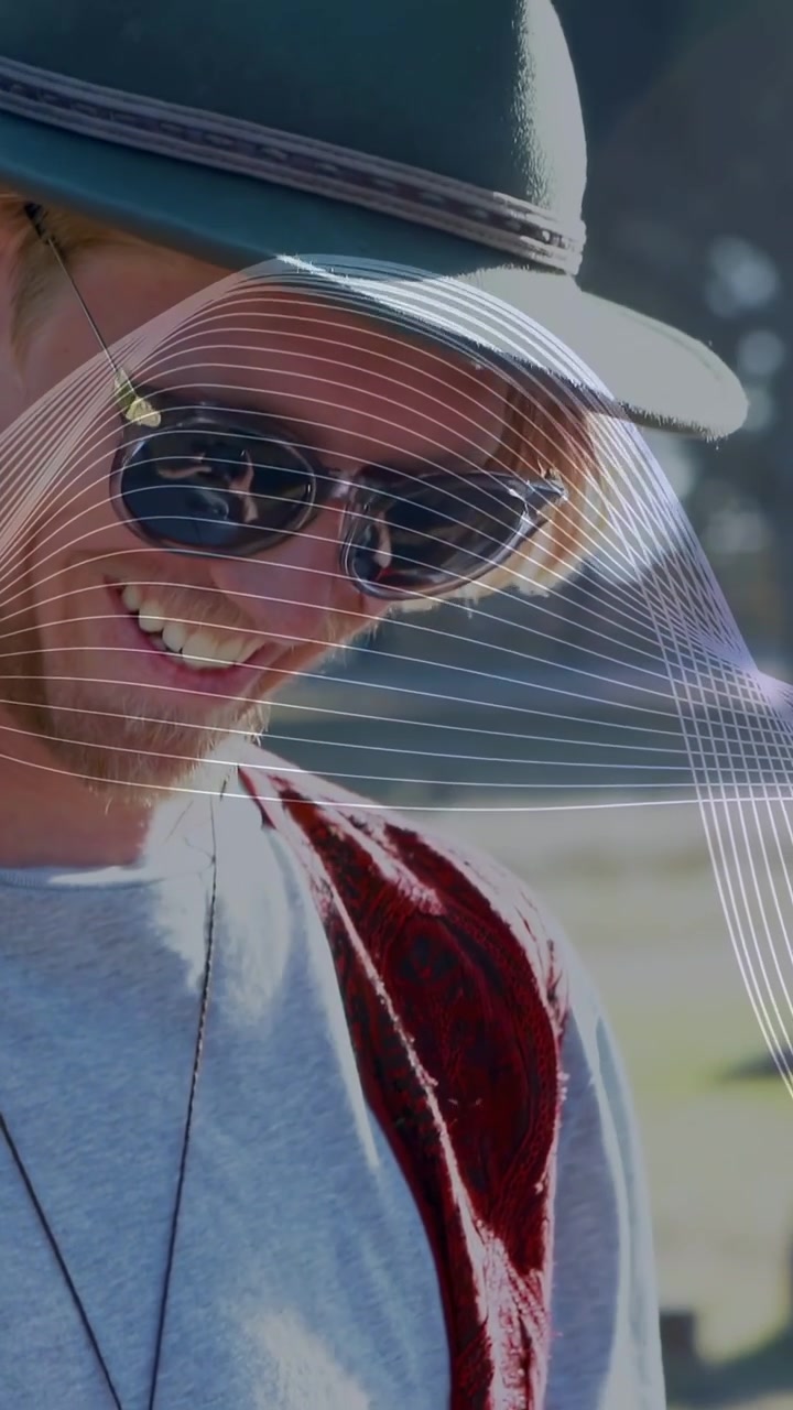 Vertical video: Man tapping phone causing white wave overlay him in tech laughing reacting to post