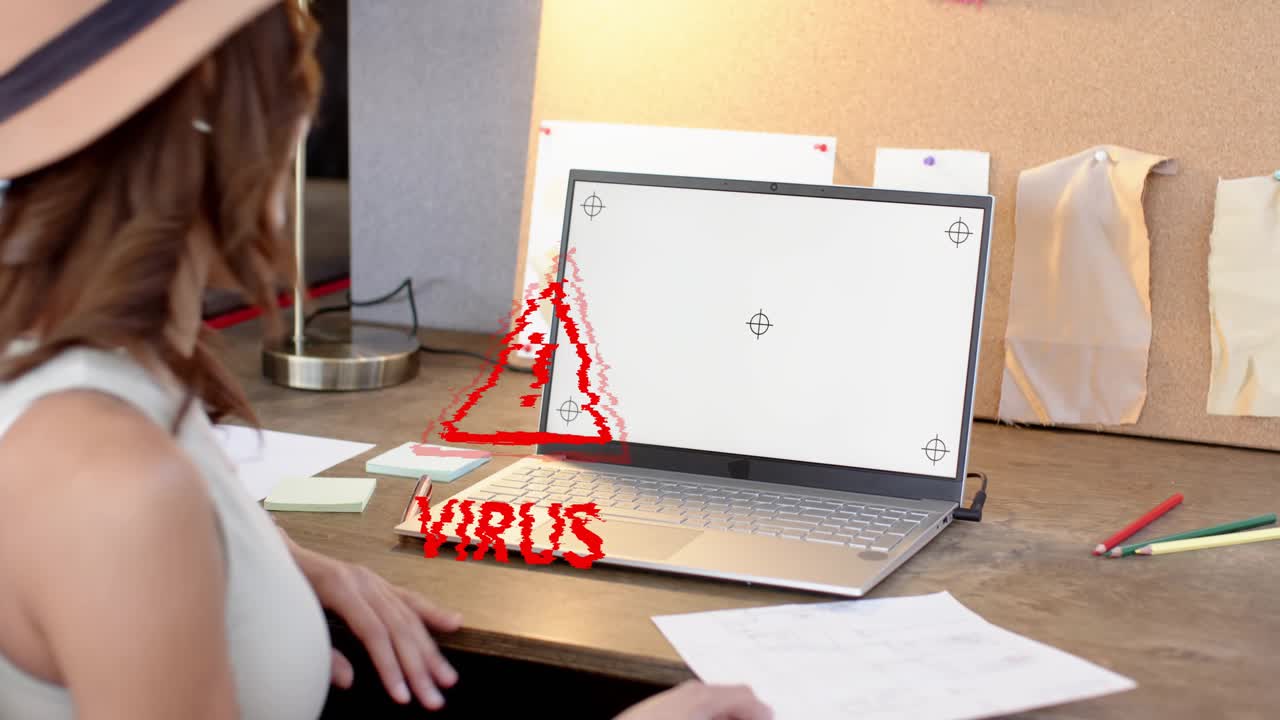 Woman at desk with paper reacting as red VIRUS overlay appearing glitching laptop checking security