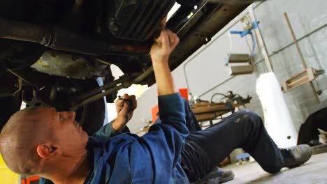 mechanic examining a car 4k