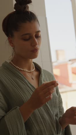 woman in robe drinking