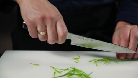 chef chopping green onions