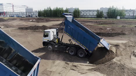 dump truck loading sand at construction site