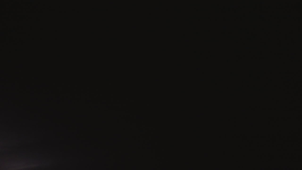 Intense lightning strikes illuminate the night sky during thunderstorm