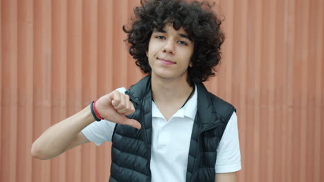 teenager with thumbs down