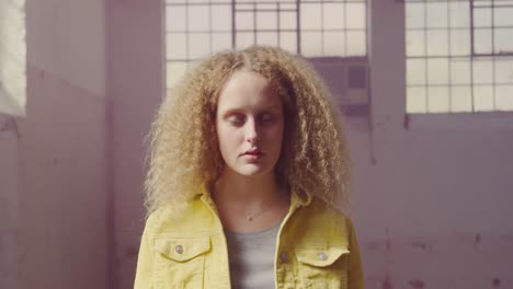 fashionable young woman in an abandoned warehouse