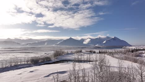 frosted mountains and white plains under blue sky near borgarfjörður iceland