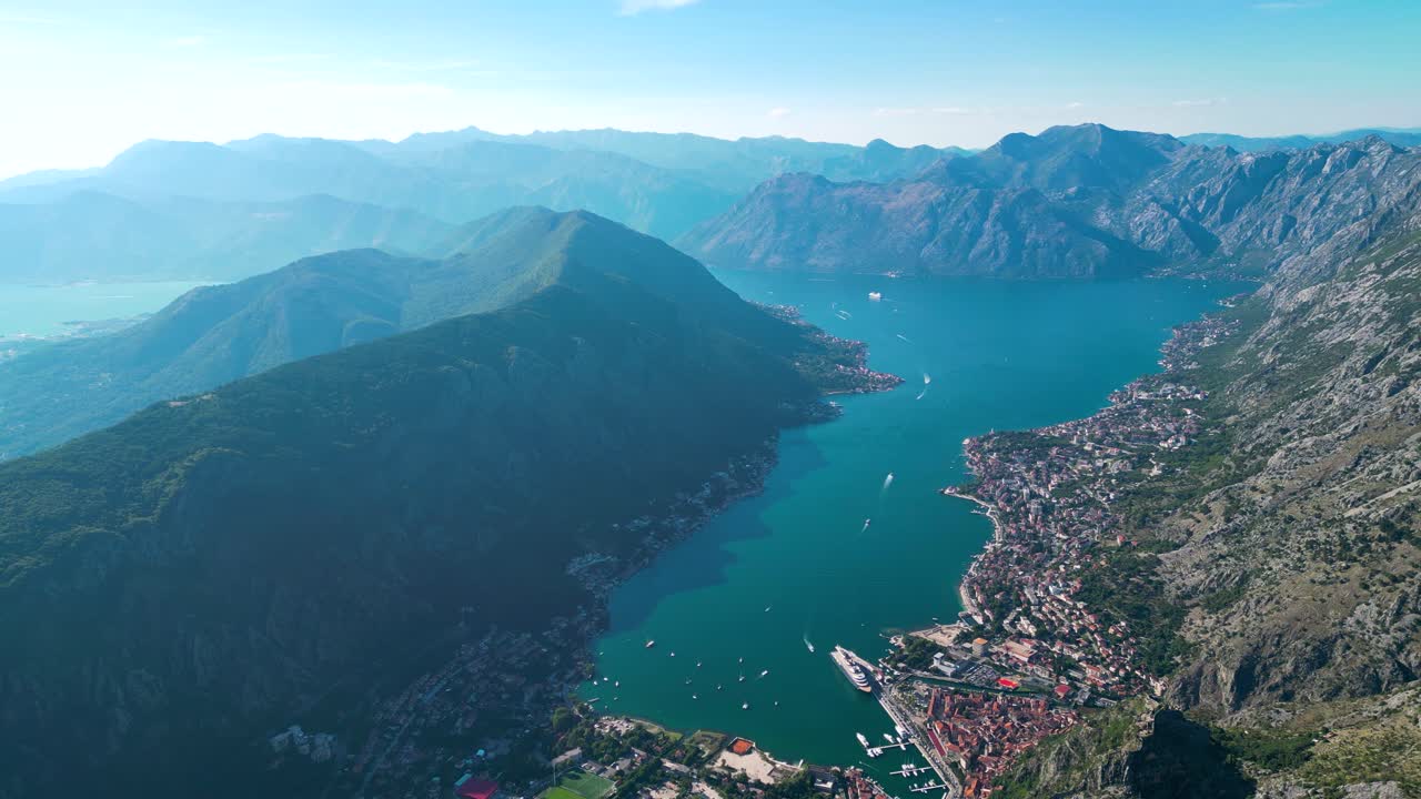 Panoramic aerial view of Kotor city. View of all region of Kotor Golf. Drone going backward. Boats and cruise ship. Famous and luxury travel destination in Montenegro. Foggy day