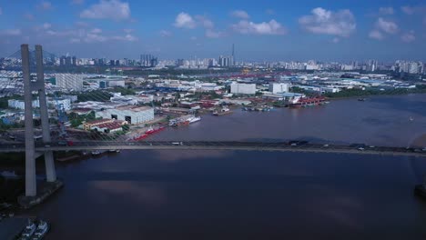 aerial view of phu my bridge over saigon river with road and river transportation on a sunny day