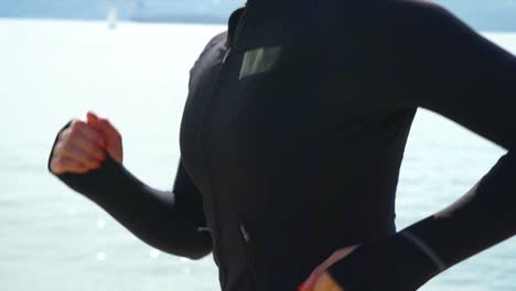 cropped shot of young woman running near river