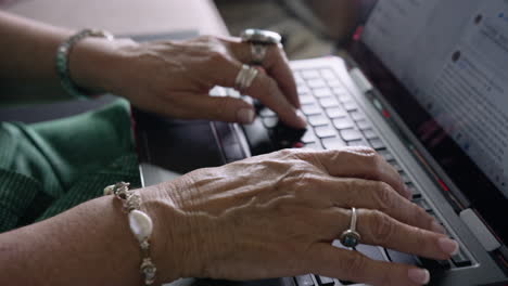 elderly woman types quickly on laptop