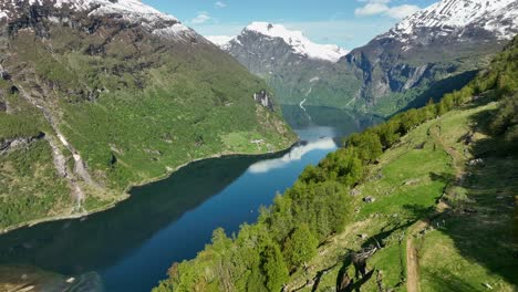 Aerial-reveal-of-famous-Geiranger-Fjord,-listed-on-Unesco-World-Heritage-List