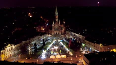 drone view of christmas stalls and carousel on the podgorski square with st