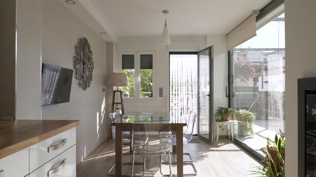 Interior of a kitchen of a bright house with glass walls