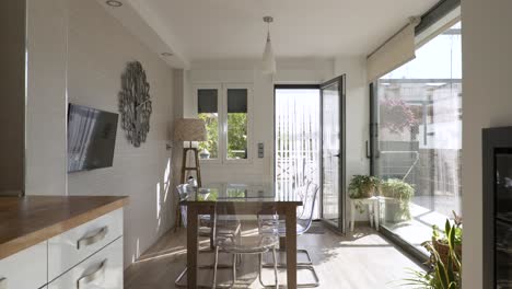interior of a kitchen of a bright house with glass walls