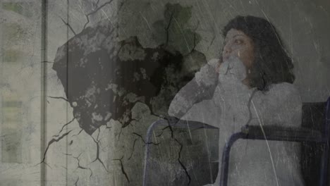 Abstract-textured-scratched-overlay-against-stressed-handicapped-woman-sitting-on-wheelchair