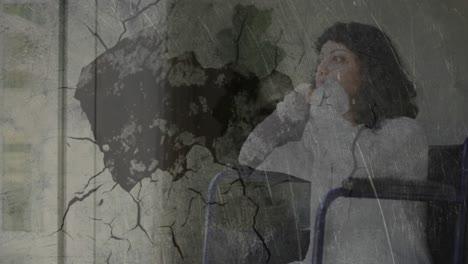 abstract textured scratched overlay against stressed handicapped woman sitting on wheelchair