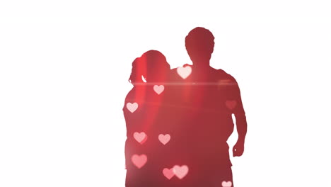 animation of hearts falling over silhouette of couple embracing