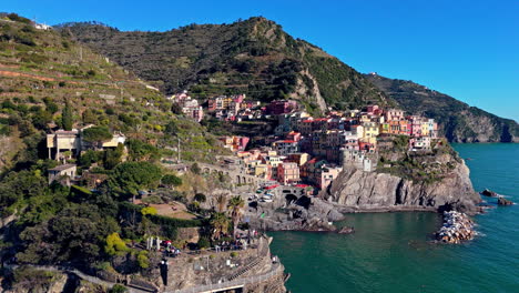manarola, colorful coastal village in cinque terre, italy, surrounded by hills