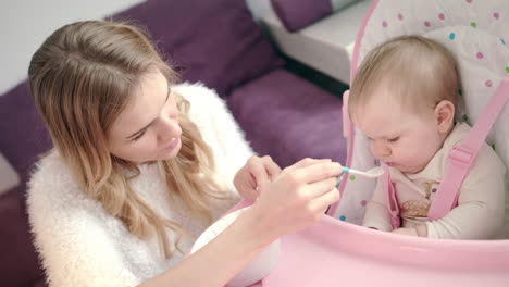 Bebé-Comiendo-Puré-Del-Tazón.-Mujer-Alimentando-A-Un-Niño-Con-Comida-Para-Bebés