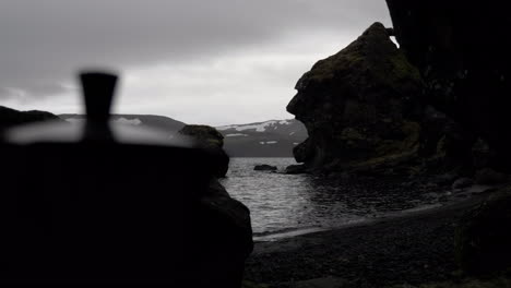 tea pot by cave opening in black and white