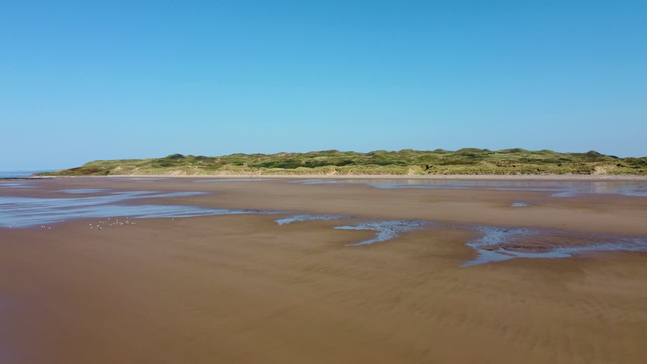 View of Grass Covered Sand Dunes on Rhossili Bay Beach with Flocks of Seagulls in Travel Summer Tourist Season 4K