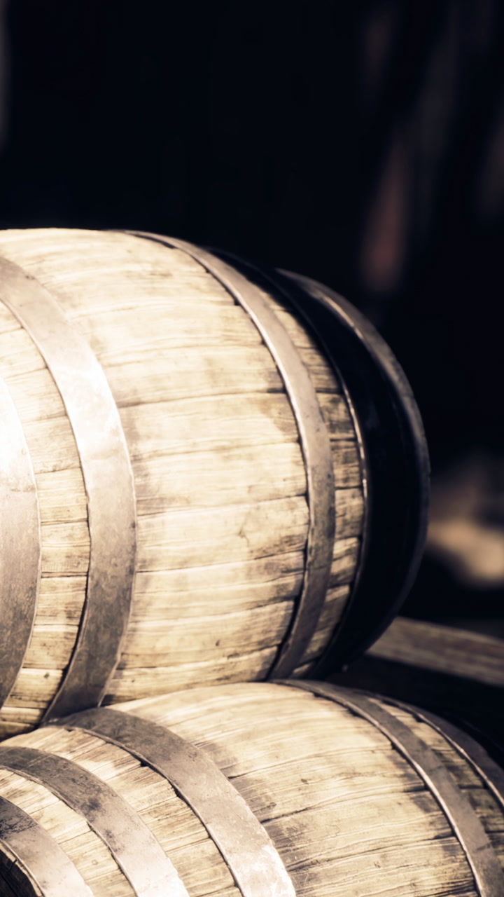 Barrels resting quietly in a dimly lit cellar waiting for their purpose