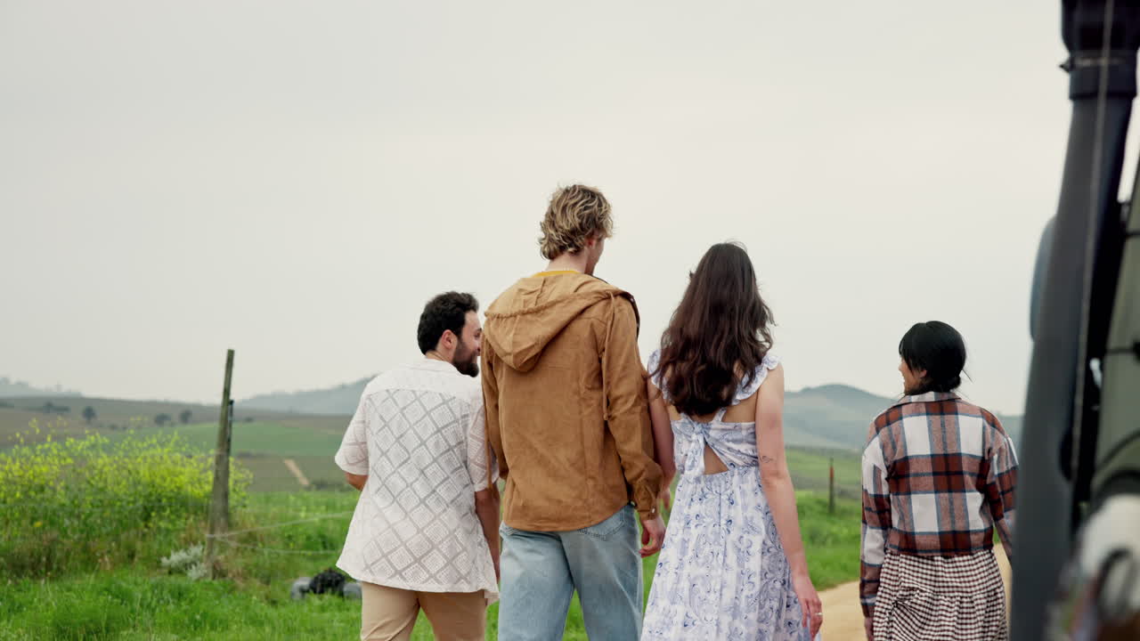 Group of friends walking on a dirt road in the countryside