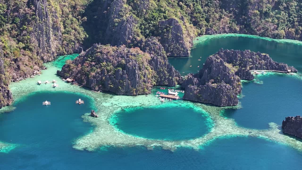 Aerial close up of Twin Lagoon, beautiful tourist attraction, natural coastal landscape. Philippines.