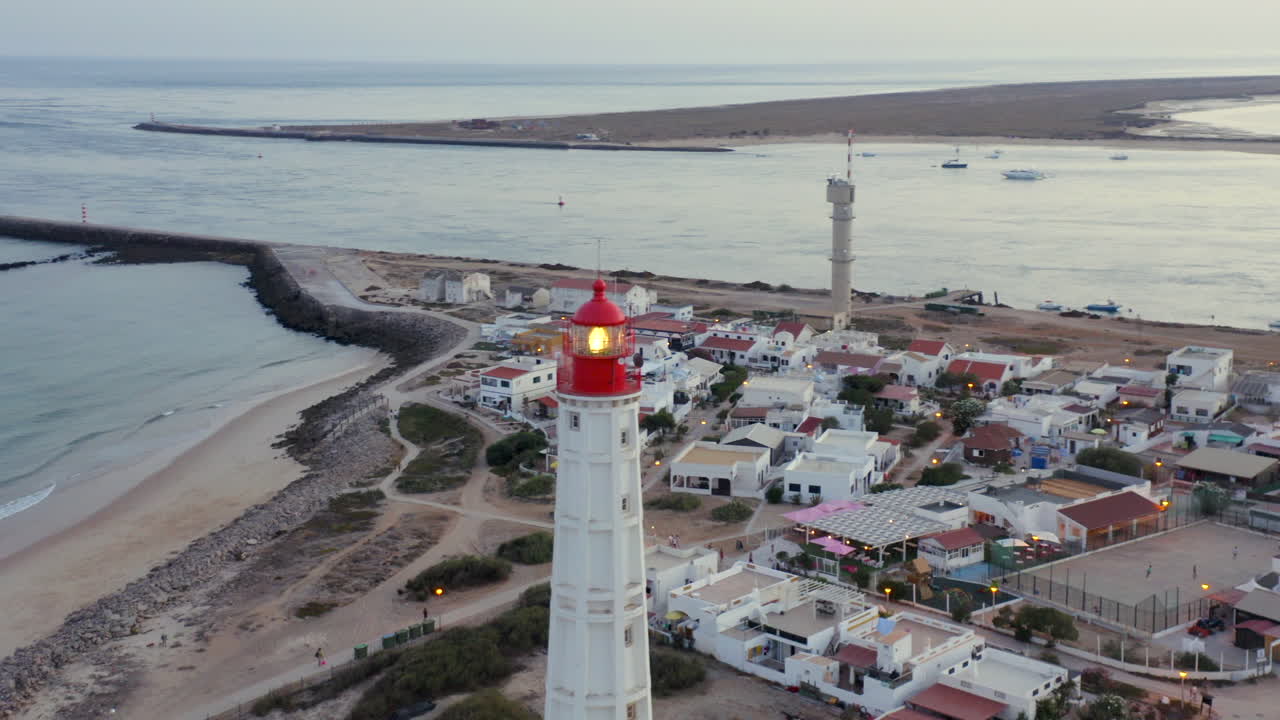 High aerial Farol Lighthouse Ilha do Farol coastal village sunset