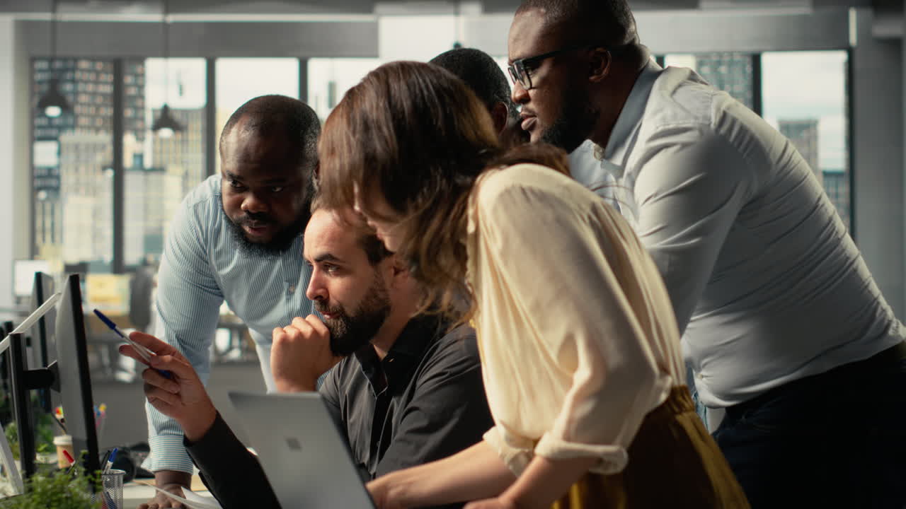 Vertical Video Diverse business people in a modern workspace collaborating on analytics