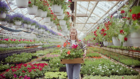 Female-Farmer-With-Flower-Plants-In-Greenhouse