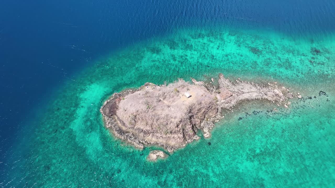 Drone reveal from small island to scenic coastal landscape of Flores, Indonesia. Sunny, travel