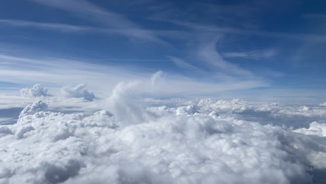 a flight above the white clouds and the sky is blue