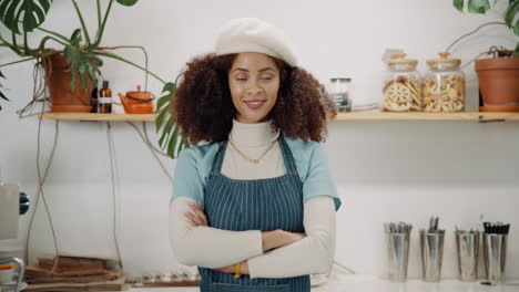 a woman in her coffee shop wearing a beret