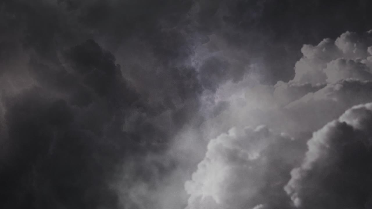 View of dark thunderstorm and thick gray clouds in the sky