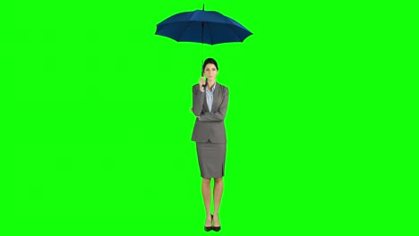 businesswoman standing under umbrella