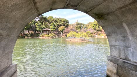 calm water and greenery framed by an archway