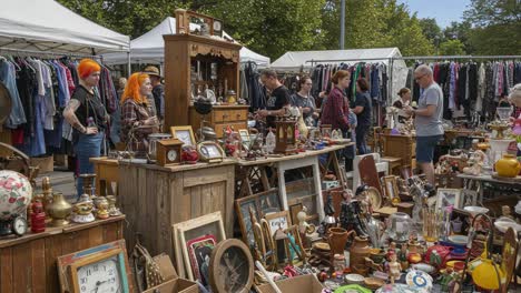 exploring a vibrant flea market filled with unique antiques, vintage collectibles, and enthusiastic shoppers engaging in a dynamic bargaining atmosphere